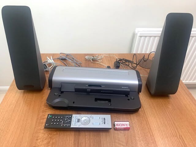 File:Speakers, docking stations and remote control.jpg